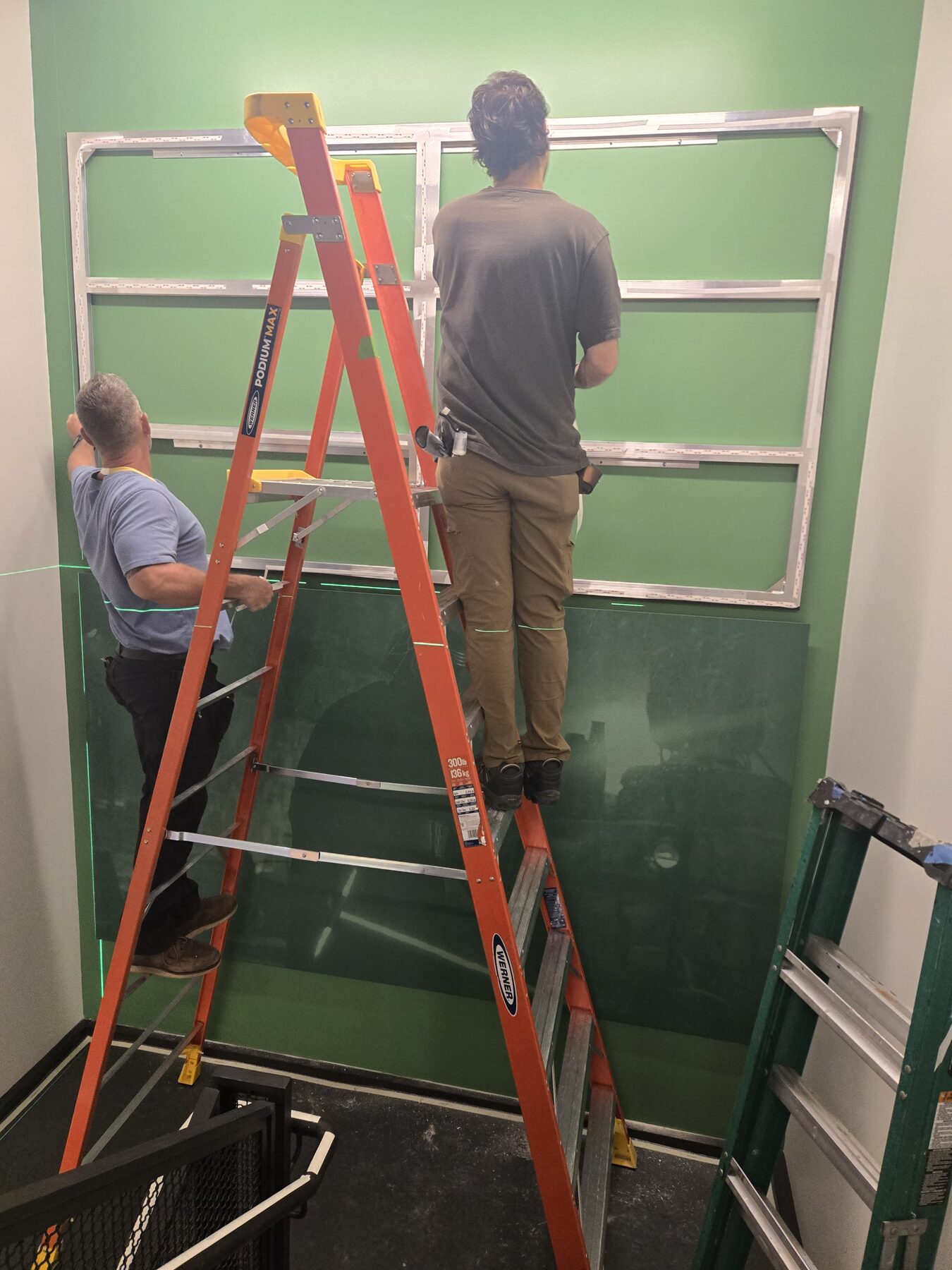 Crew installing commercial wall framing system