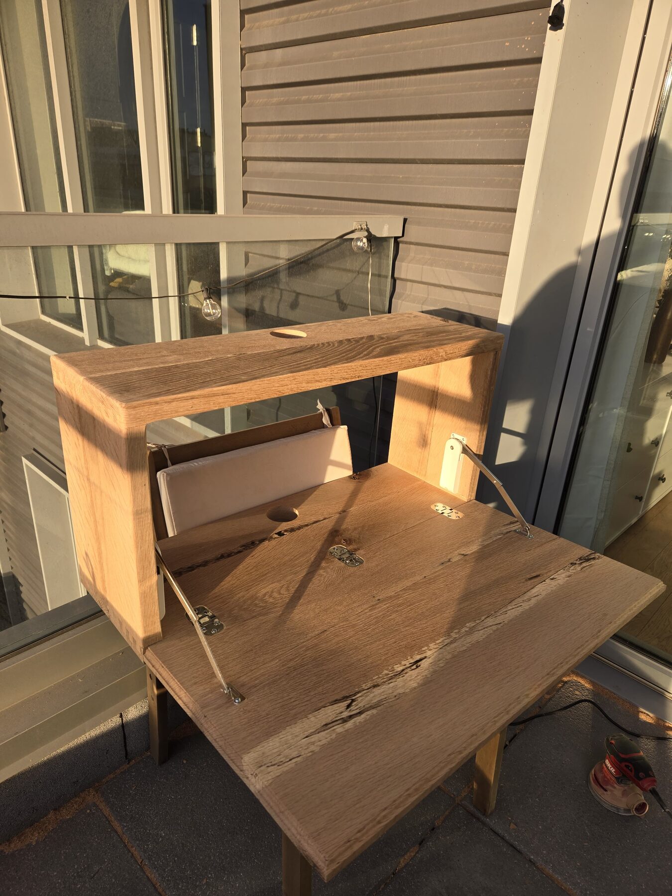 Solid oak console with hand-cut dovetail joinery, golden hour light